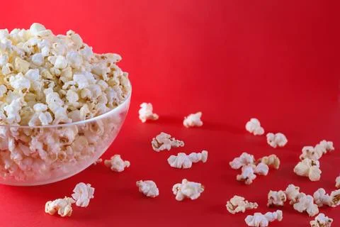 Popcorn on a bright red background top view Stock Photos