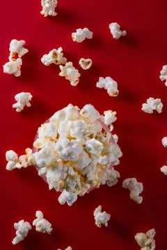 Popcorn on a bright red background top view Stock Photos