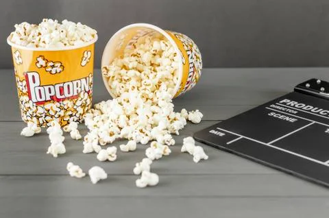 Popcorn buckets next to a clapperboard Stock Photos