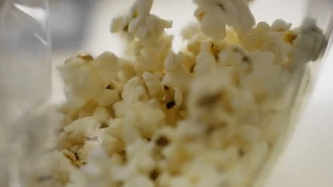 Popcorn cascades into a transparent bag. The visual and auditory spectacle Video stock 248583088