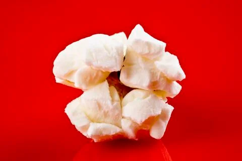 Popcorn closeup on red background Stock Photos