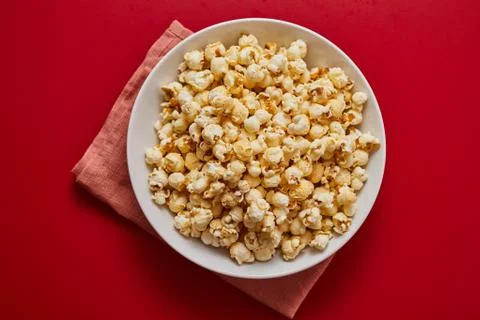 Popcorn on color background.. Stock Photos