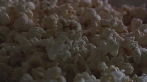 Popcorn with colored highlights from the screen. Stock Footage 155085767