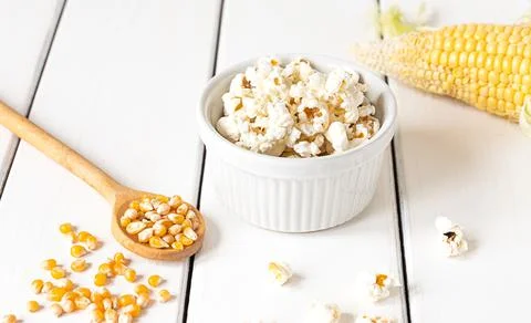 Popcorn, corn cob and corn grains on white background Stock Photos