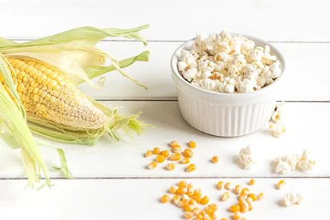Popcorn, corn cob and corn grains on white background Stock Photos