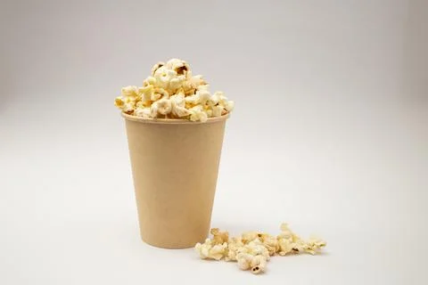 Popcorn in a cup on a white background Stock Photos