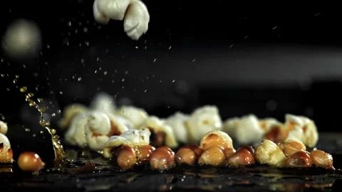 Popcorn explodes in the pan. Filmed on a high-speed camera at 1000 fps. Stock Footage 308462096