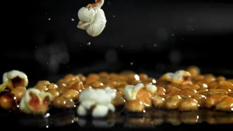 Popcorn explodes in the pan. Filmed on a high-speed camera at 1000 fps. Stock Footage 308462768
