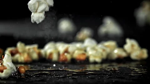 Popcorn explodes in the pan. Filmed on a high-speed camera at 1000 fps. Stock Footage 308462798