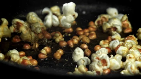 Popcorn explodes in the pan. Filmed on a high-speed camera at 1000 fps. Stock Footage 308463000