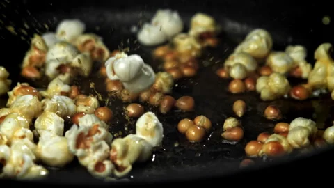 Popcorn explodes in the pan. Filmed on a high-speed camera at 1000 fps. Stock Footage 308463121