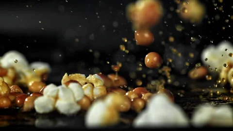 Popcorn explodes in the pan. Filmed on a high-speed camera at 1000 fps. Stock Footage 308463261