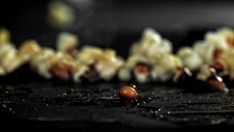 Popcorn explodes in the pan. Filmed on a high-speed camera at 1000 fps. Stock Footage 308463321