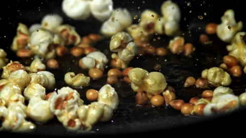 Popcorn explodes in the pan. Filmed on a high-speed camera at 1000 fps. Stock Footage 308463700