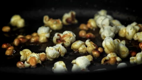 Popcorn explodes in the pan. Filmed on a high-speed camera at 1000 fps. Stock Footage 309205969