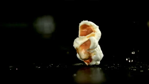 Popcorn explodes in a pan with a splash of oil. Filmed on a high-speed camera at Stock Footage 263251815