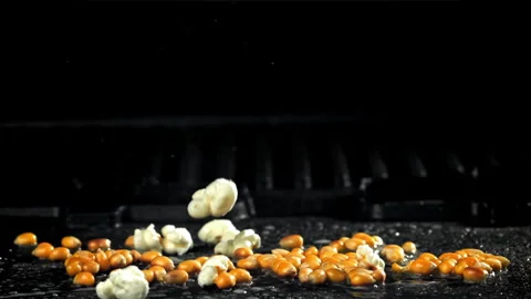 Popcorn explodes in a pan with a splash of oil. Filmed on a high-speed camera at Stock Footage 263284267