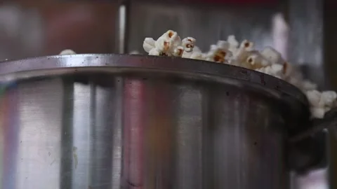 Popcorn exploding and overflowing from a stainless steel pot Stock Footage 314134561