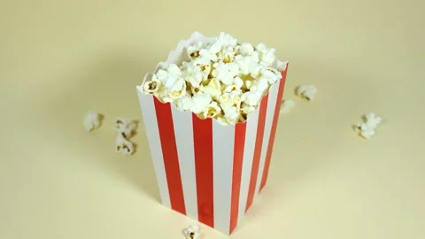 Popcorn falling into a cardboard bucket Stock Footage 288453280