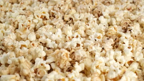 Popcorn falling dow and rotating. pour popcorn close up Stock Footage 138243638
