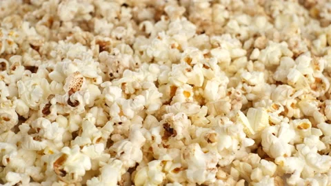 Popcorn falling dow and rotating. pour popcorn close up Stock-Footage 138243643