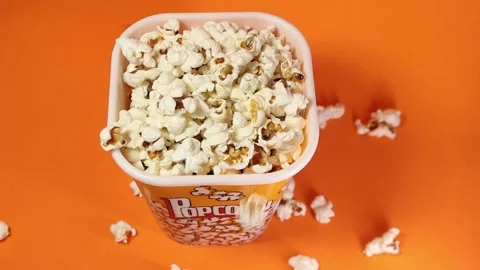 Popcorn falling down in beautiful bowl Stock Footage 244164374