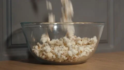 Popcorn falling down in glass bowl Stock Footage 159550089
