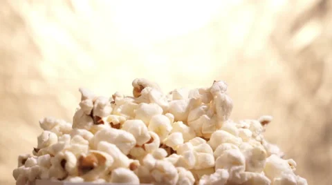 Popcorn falling on golden background Stock Footage 67675151