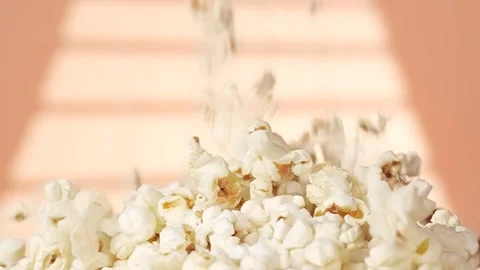 Popcorn falling into the pile, close up, slow motion Stock Footage 299374266