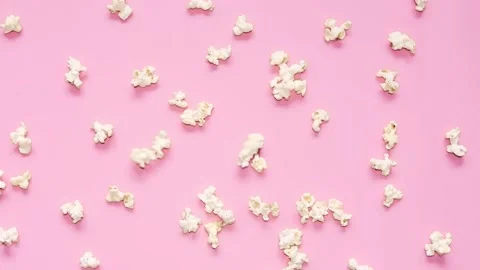 Popcorn falling on pink background. Fresh fluffy popcorn. Stock Footage 138892621