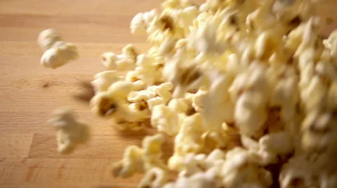 Popcorn falling onto table in slow motion Stock Footage 55246394