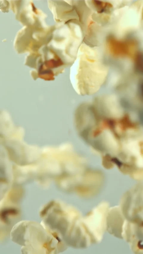 Popcorn flies up and falls down. On a light background. Filmed on a high-speed Stock Footage 335359866