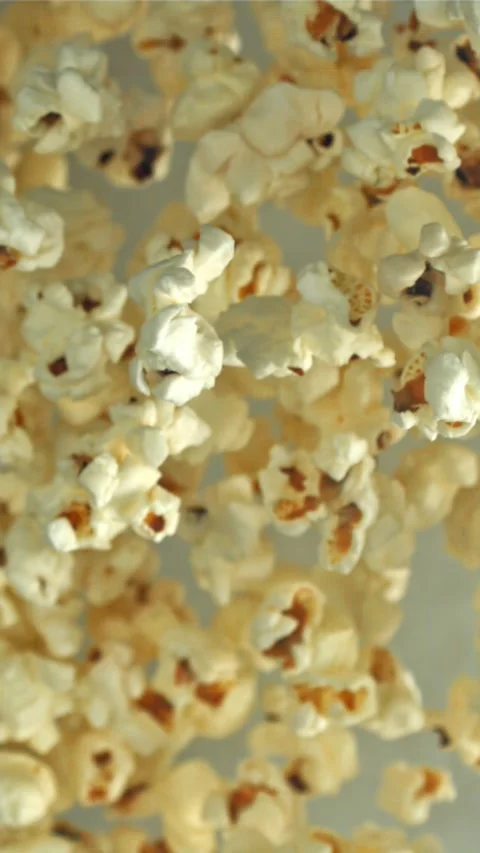 Popcorn flies up and falls down. On a light background. Filmed on a high-speed Stock Footage 335360936