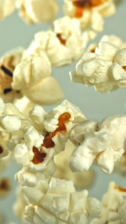 Popcorn flies up and falls down. On a light background. Filmed on a high-speed Stock Footage 335360994