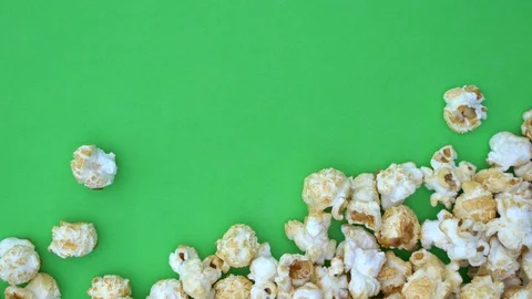 Popcorn flies into the scene. Green background allows keying. The popcorn is Stock Footage 105596374