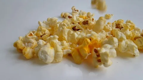 Popcorn flies on a white background slow motion Stock Footage 87954167