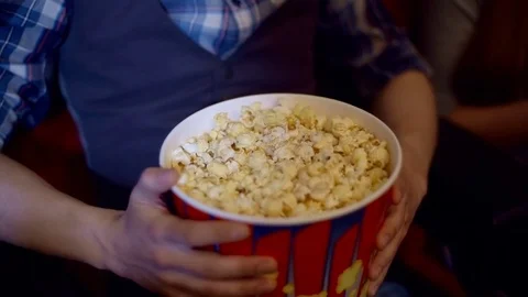 Popcorn forever. Closeup cropped shot of a happy smiling woman grabbing popcorn 스톡 동영상 75037233