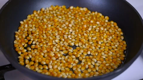 Popcorn kernels being fried in a pan. Stock Footage 332700714
