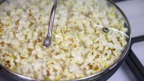 Popcorn kernels popping in a hot pan. Stock Footage 330687521