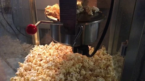 Popcorn machine hand dumps popcorn Stock Footage 72785157