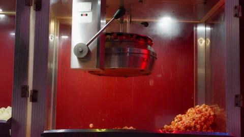 Popcorn machine making fresh buttery popped corn inside a glass case with a.. Stock Footage 338189237