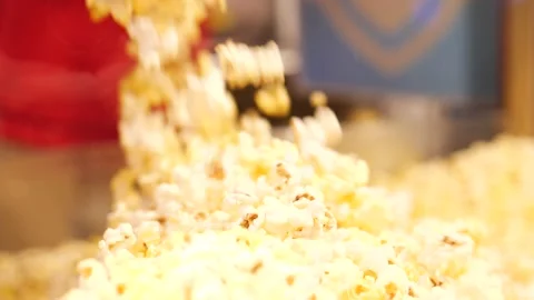 Popcorn made fresh spilling over the edge of a pot or machine Stock Footage 166664142