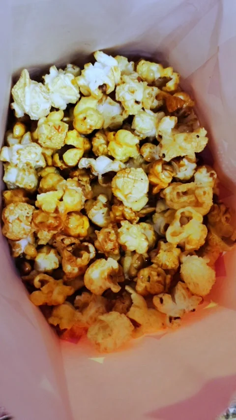 Popcorn in a paper bag closeup view from above. Stock Footage 280189594