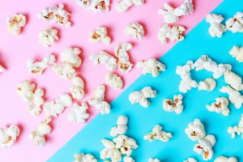Popcorn pattern on blue and pink background close-up, top view Stock Photos