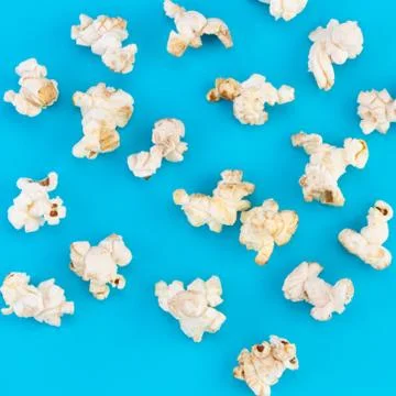 Popcorn pattern on blue  background. Top view Stock Photos