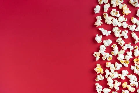 Popcorn pattern, border on red background. Top view, flat lay with copy space Stock Photos