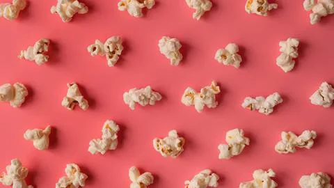Popcorn pattern on pink background Stock Photos