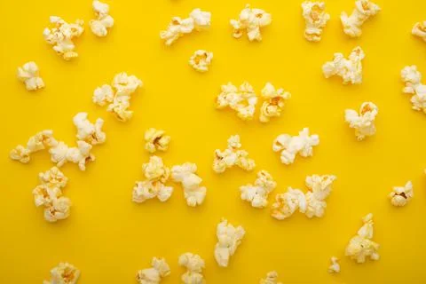 Popcorn pattern, texture on a yellow background. Top view, entertainment, mov Stock Photos
