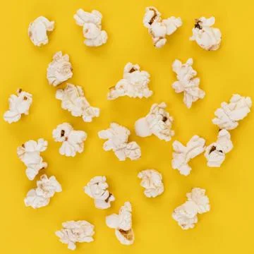 Popcorn pattern on yellow background. Top view Stock Photos