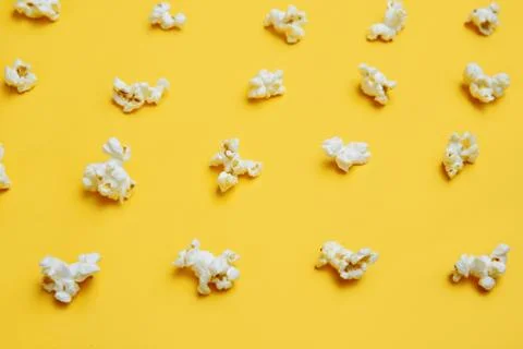 Popcorn pattern on yellow background. Top view. Entetainement concept Stock Photos